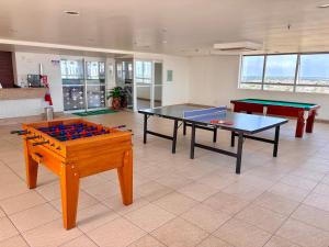 a room with two ping pong tables in a room at Apart-hotel Premium Adrianópolis in Manaus