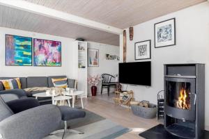 a living room with a couch and a fireplace at 6736-Allinge-Thorkildsvej-8 in Allinge