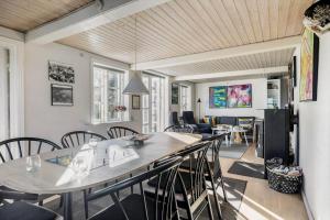 a living room with a table and chairs at 6736-Allinge-Thorkildsvej-8 in Allinge