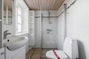 a bathroom with a toilet and a sink and a shower at 6736-Allinge-Thorkildsvej-8 in Allinge +25 photos