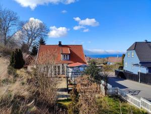 a house with a red roof on a hill at 6736-Allinge-Thorkildsvej-8 in Allinge