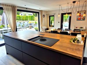 a kitchen with a counter with a sink in it at Chez Simone Liège, bain nordique in Boncelles