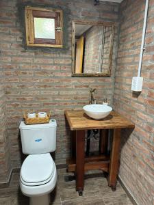 a bathroom with a toilet and a sink at Hosteria Miyazato Inn in El Calafate