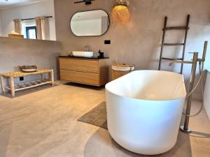 a bathroom with a white tub and a sink at Chez Simone Liège, bain nordique in Boncelles +20 photos