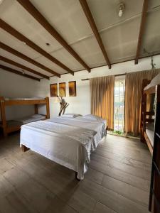 a bedroom with a large bed in a room at Gaudy's Hotel in San José