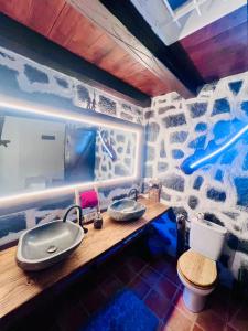 a bathroom with a sink and a rock wall at Casita Barranco del agua in Yaiza