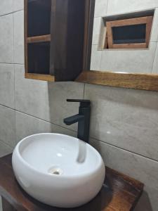 a bathroom with a white sink with a faucet at Cabana com Piscina in Annitapolis