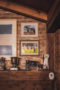 a brick wall with pictures of cows on it at Los Rebeldes in Baggle