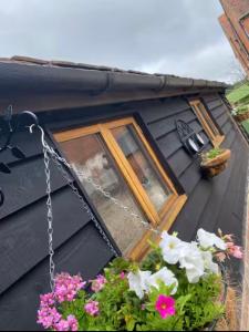 a window of a black house with flowers at Tranquil detached barns in Sherborne St John in Sherborne Saint John
