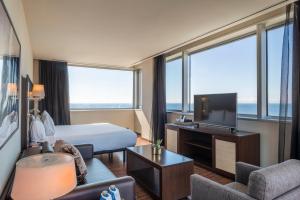 a hotel room with a bed and a television at Leonardo Royal Hotel Barcelona Forum in Barcelona