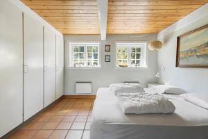 a bedroom with two beds and a wooden ceiling at 5617-Svaneke-Per-Sorens-Gade-2 in Svaneke