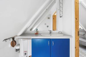 a bathroom with a blue cabinet and a sink at 5617-Svaneke-Per-Sorens-Gade-2 in Svaneke