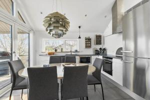 a kitchen with a dining room table and chairs at 6663-Allinge-Stien-4 in Allinge +15 photos
