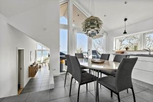 a kitchen and dining room with a table and chairs at 6663-Allinge-Stien-4 in Allinge