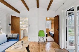 a living room with a blue couch and a green chair at 4743-Ronne-Stampen-Vej-4-Hus-4 in Rønne
