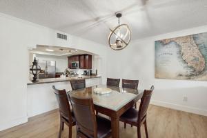 a dining room with a table and chairs at Beach Cottage 1104 in Clearwater Beach