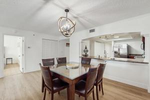 a kitchen and dining room with a table and chairs at Beach Cottage 1104 in Clearwater Beach