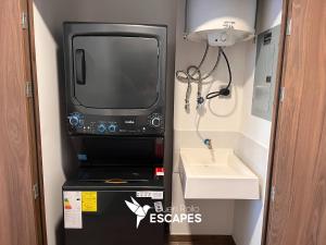 a bathroom with a tv and a sink in a room at Luxury High-Floor 3 Bedroom Apartment FREE Pool & Gym in Guatemala +50 photos