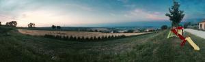 a field with a flag on the side of a road at Agriturismo Colle Tripio in Guardiagrele