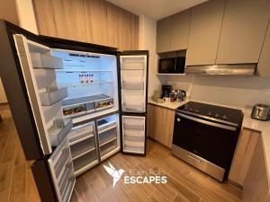 a kitchen with an open refrigerator with its door open at Luxury High-Floor 3 Bedroom Apartment FREE Pool & Gym in Guatemala