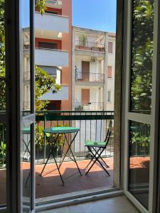 a table and chair on a balcony with a building at Hotel Brivio in Milan +58 photos