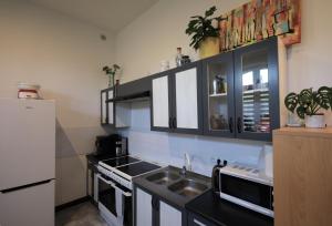 a kitchen with a sink and a white refrigerator at Stacja Binino in Binino