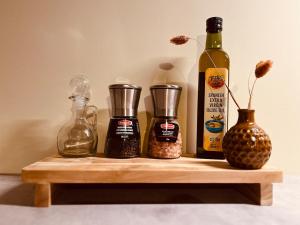 a wooden shelf with bottles of spices and a bottle of wine at De Poverleute in Kortrijk