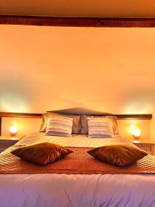 a bedroom with a bed with two pillows on it at De Poverleute in Kortrijk
