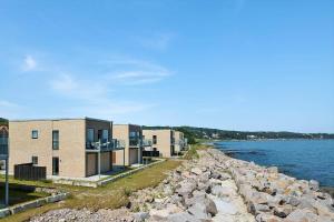 a row of buildings next to a body of water at 4797-Allinge-Havnevej-14-C-1-th in Allinge