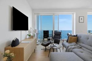 a living room with a couch and a view of the ocean at 4797-Allinge-Havnevej-14-C-1-th in Allinge