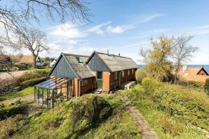 a small house on top of a hill at 5634-Svaneke-Bolshavn-29-A in Svaneke