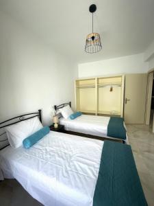 two beds sitting next to each other in a bedroom at Aethera Apartments in Megalochori