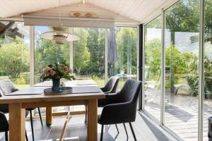a dining room with a table and chairs and sliding glass doors at 6832-Hasle-Toftegardsvej-20-C in Hasle +15 photos