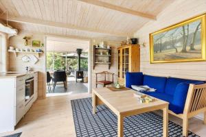 a caravan living room with a blue couch and a table at 6832-Hasle-Toftegardsvej-20-C in Hasle