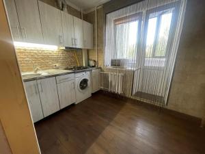 a kitchen with a sink and a washing machine at Квартира на Ивана Сирка 2 in Sumy