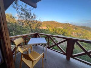 a table and chairs on a balcony with a view at Charming Ocean View Apartment, Casa Xochi in San Agustinillo