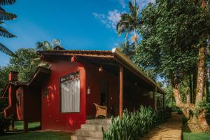 a red house with a staircase leading to it at Pousada Hakuna Matata in Morretes +11 photos