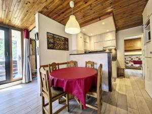 a dining room with a red table and chairs at Residence De L'isere - Grand appartement dans le centre MAE-1713 in Val dʼIsère