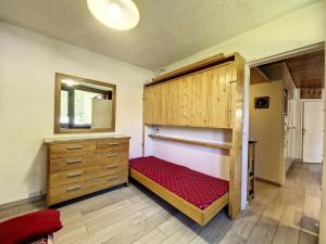 a bedroom with a bed and a dresser and a mirror at Residence De L'isere - Grand appartement dans le centre MAE-1713 in Val dʼIsère