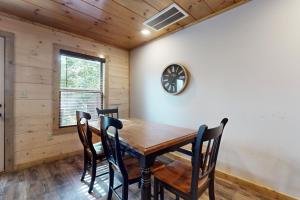 a dining room with a wooden table and chairs at Bear Cove Falls Unit 1 in Pigeon Forge