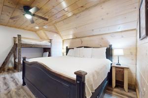 a bedroom with a bed with a ceiling fan at Bear Cove Falls Unit 1 in Pigeon Forge +43 photos