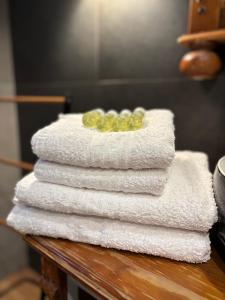 a stack of towels on a table in a bathroom at Old Town Sibiu Apartment - Historical Center Residence in Sibiu +83 photos