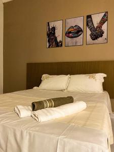 a bed with two towels on top of it at Casa No Centro de Caldas Novas in Caldas Novas
