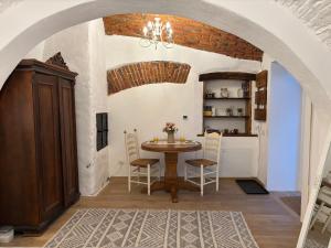 a kitchen and dining room with a table and chairs at Old Town Sibiu Apartment - Historical Center Residence in Sibiu