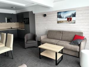 a living room with a couch and a table and a kitchen at Résidence Le Portillo - Piscine - Studio pour 6 Personnes MAE-4503 in Gourette