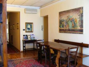 a dining room with a table and a painting on the wall at Soggiorno Michelangelo in Florence