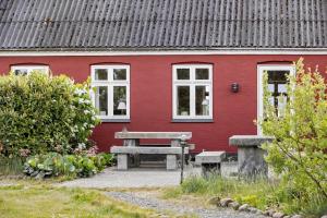 a red house with a picnic table in front of it at 3691-Nexo-Stensebyvejen-32 in Neksø