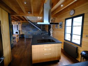 a kitchen with a island in a tiny house at Chalet Montagne in Saint-Pastous