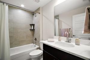a bathroom with a sink and a toilet and a tub at Brand New House Near WEC And FAST in Ocala +12 photos