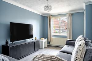 ein Wohnzimmer mit Couch und Flachbildfernseher in der Unterkunft Cozy 2-Bed Home in Middleton in Middleton